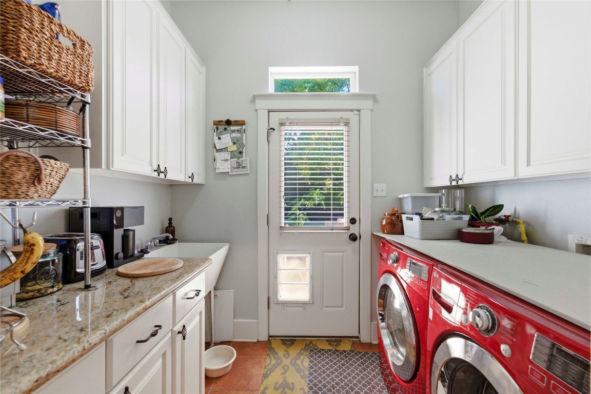 2128 Sage Creek Loop Austin, TX 78704 - Photo 13 of 32 a kitchen with stainless steel appliances granite countertop a sink stove and cabinets