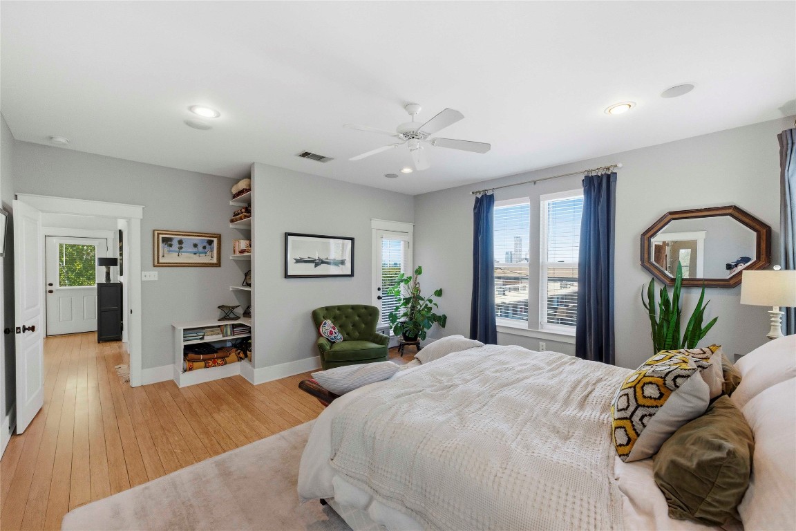 2128 Sage Creek Loop Austin, TX 78704 - Photo 16 of 32 a bedroom with a bed and a chandelier