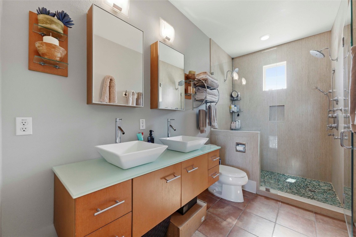 2128 Sage Creek Loop Austin, TX 78704 - Photo 17 of 32 a bathroom with a sink mirror and toilet