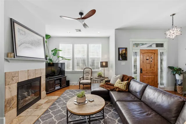 a living room with furniture a fireplace and a flat screen tv