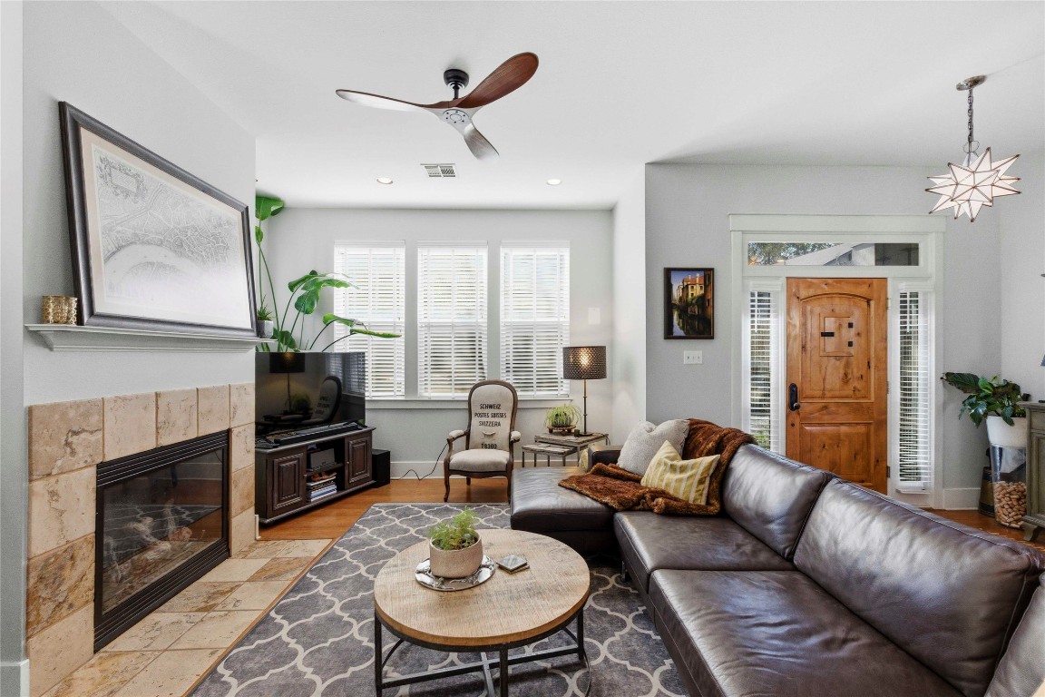 2128 Sage Creek Loop Austin, TX 78704 - Photo 2 of 32 a living room with furniture a fireplace and a flat screen tv