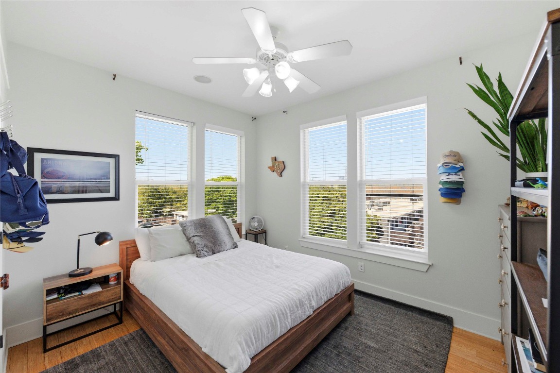 2128 Sage Creek Loop Austin, TX 78704 - Photo 19 of 32 a bedroom with a large bed and a window