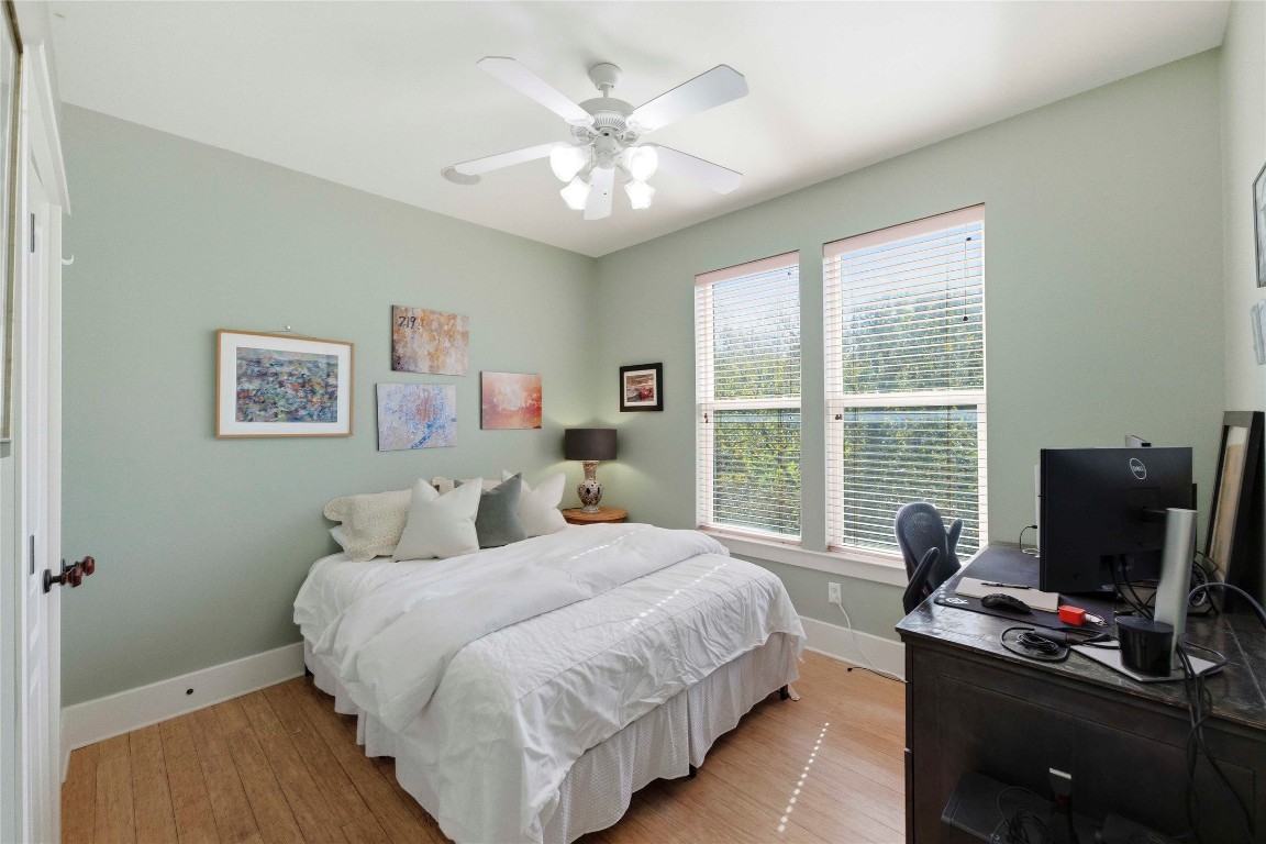 2128 Sage Creek Loop Austin, TX 78704 - Photo 21 of 32 a bedroom with a bed and a desk