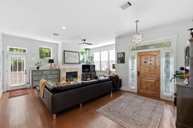 a living room with furniture and a chandelier