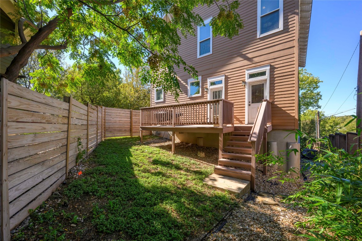 2128 Sage Creek Loop Austin, TX 78704 - Photo 30 of 32 a view of a backyard with wooden fence and a tree