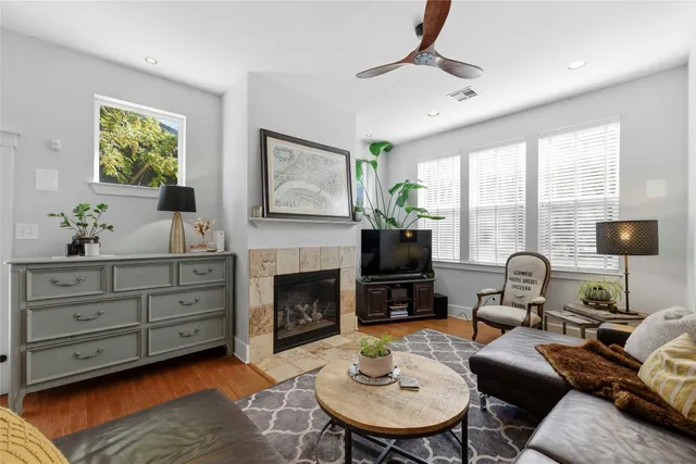 a living room with furniture a fireplace and a flat screen tv
