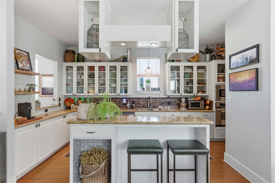 2128 Sage Creek Loop Austin, TX 78704 - Photo 9 of 32 a kitchen with a sink and a refrigerator
