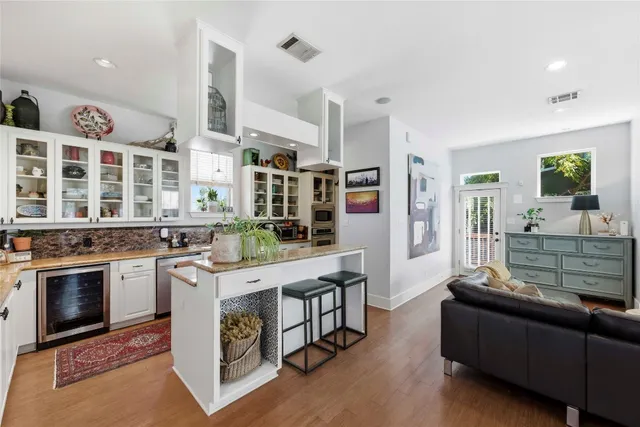 a kitchen with stainless steel appliances granite countertop a stove and cabinets