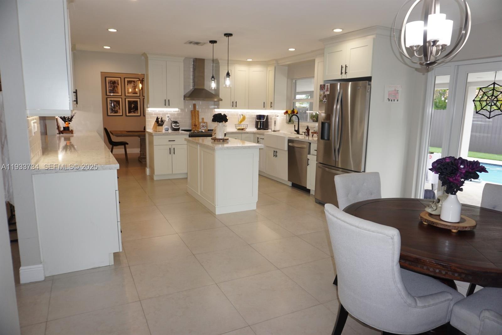 10350 Southwest 16th Street Miami, FL 33165 - Photo 15 of 48 a kitchen with refrigerator and chairs