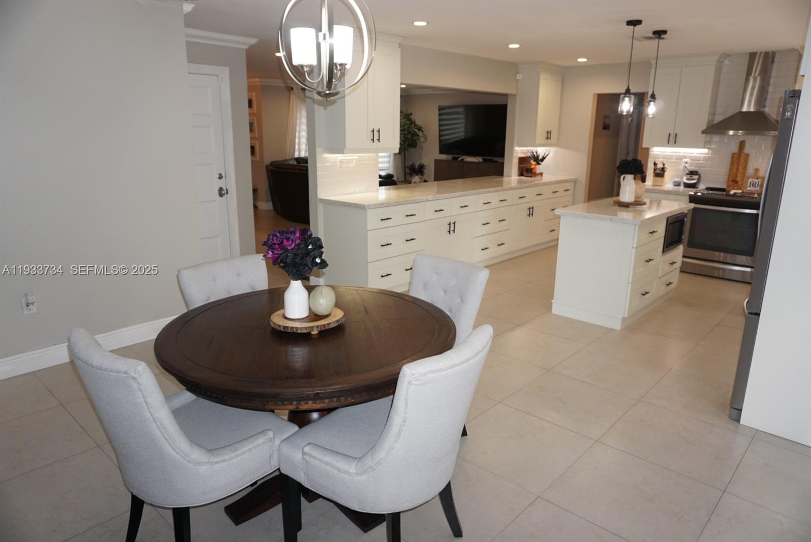 10350 Southwest 16th Street Miami, FL 33165 - Photo 17 of 48 a kitchen with stainless steel appliances a dining table and chairs