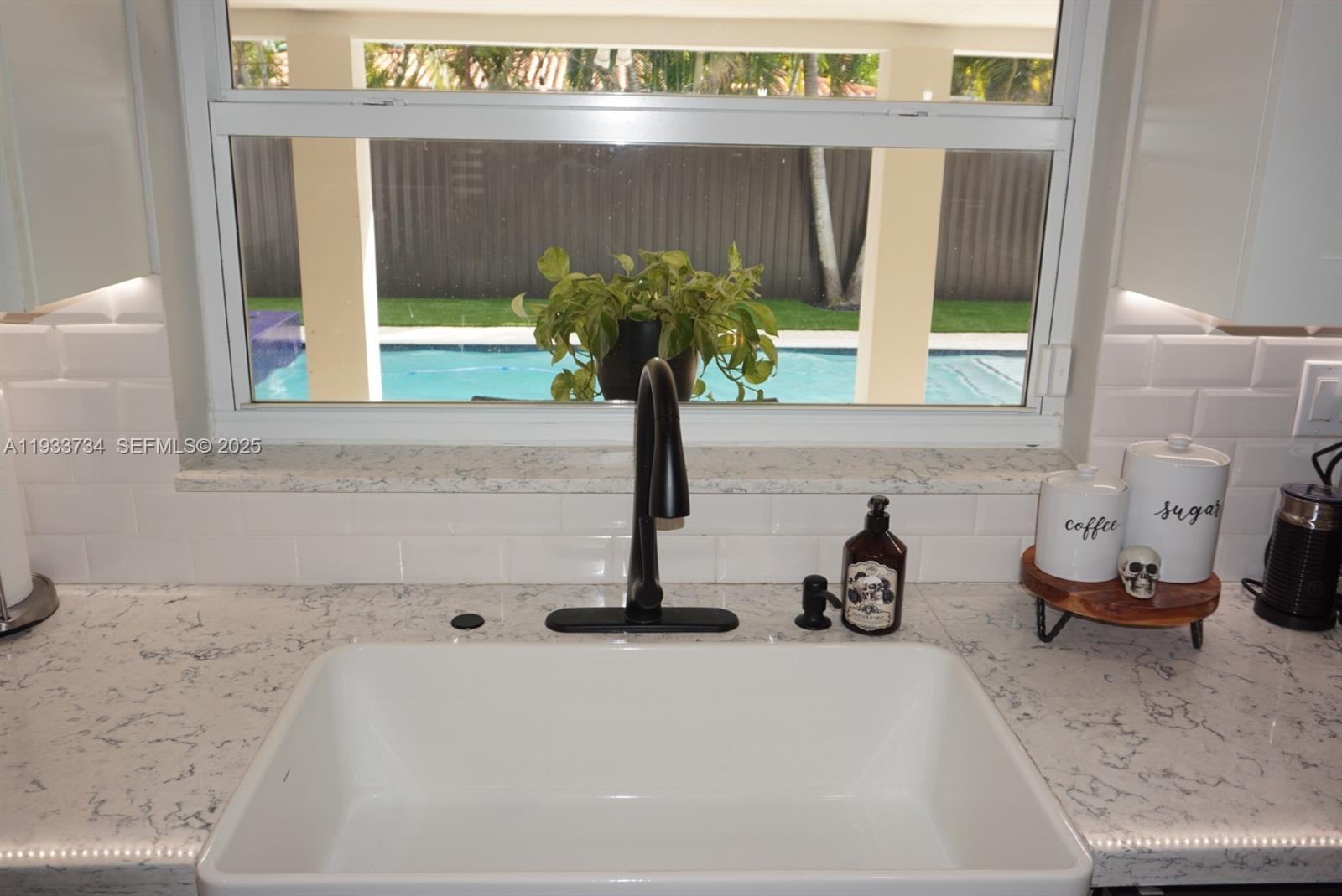10350 Southwest 16th Street Miami, FL 33165 - Photo 23 of 48 a bathroom with a sink and a window