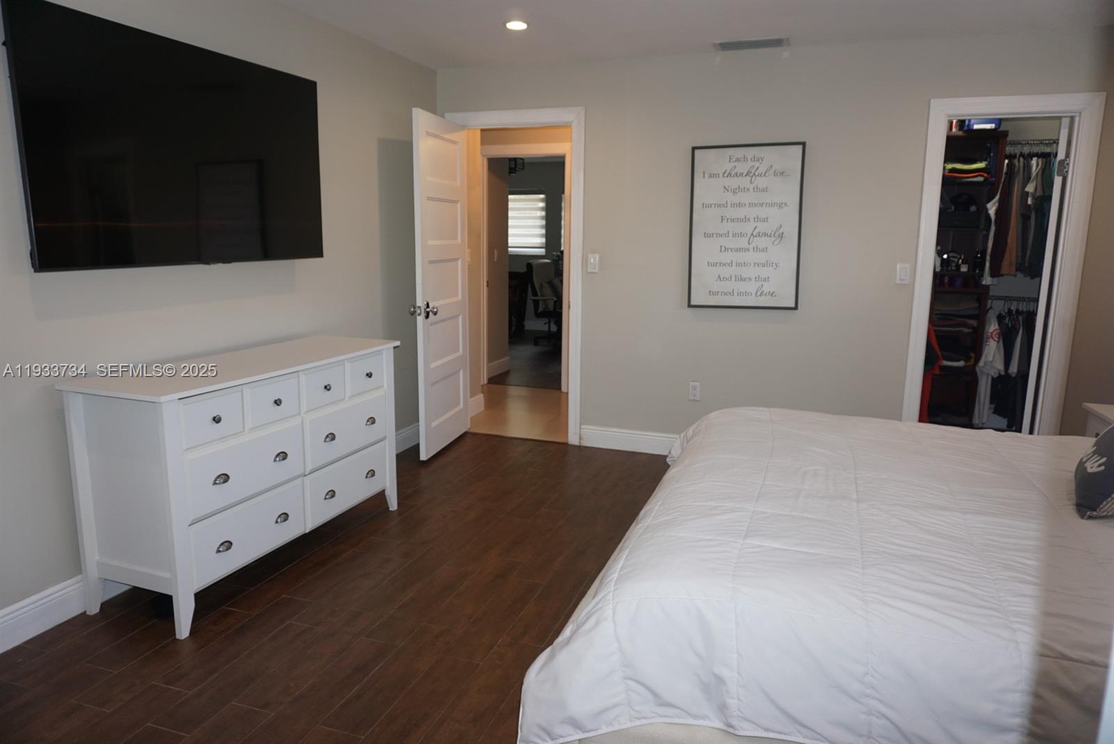 10350 Southwest 16th Street Miami, FL 33165 - Photo 29 of 48 a bedroom with a bed and a flat tv screen on dresser