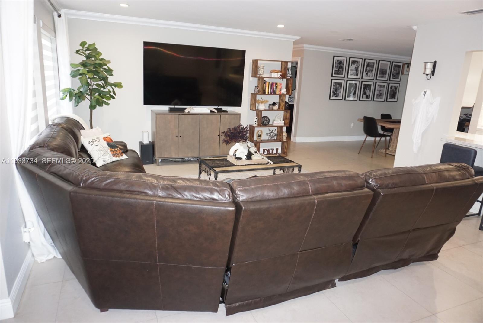10350 Southwest 16th Street Miami, FL 33165 - Photo 5 of 48 a living room with furniture and a flat screen tv