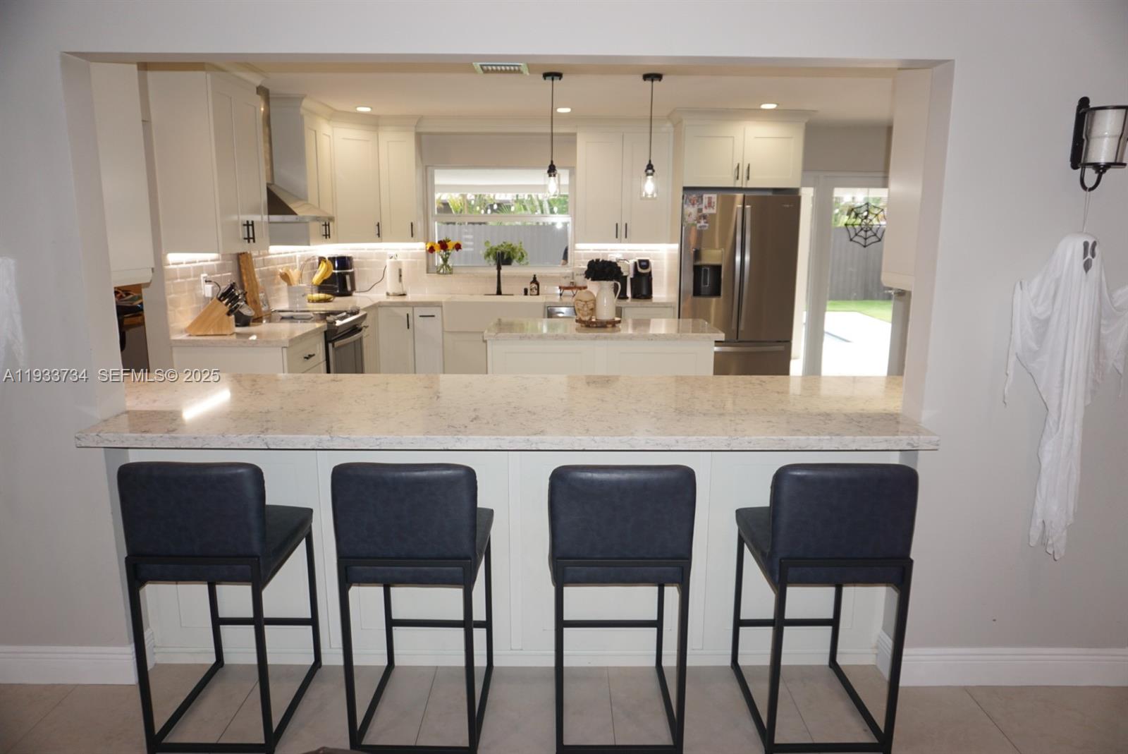 10350 Southwest 16th Street Miami, FL 33165 - Photo 10 of 48 a kitchen with stainless steel appliances granite countertop table chairs sink and cabinets