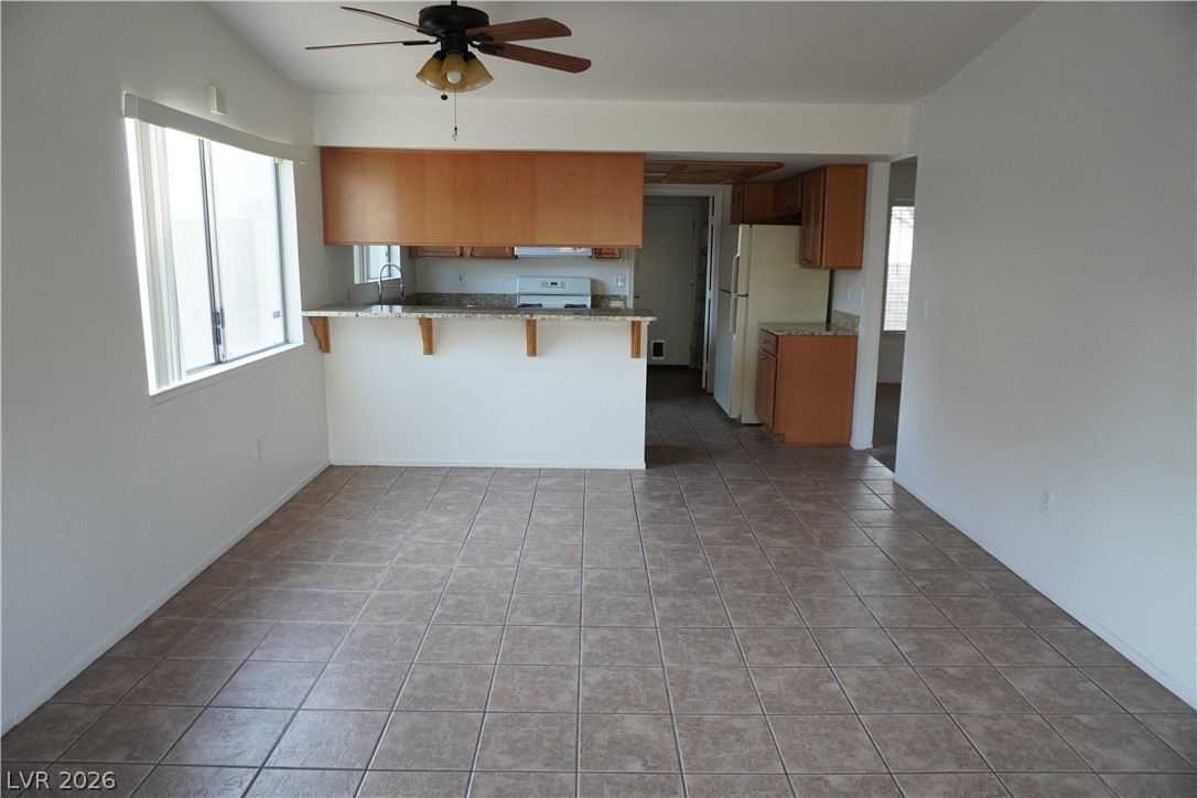 8328 Del Rey Avenue Las Vegas, NV 89117 - Photo 19 of 38 Functional kitchen with wood cabinetry and a convenient breakfast bar for casual dining.