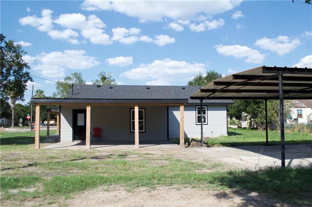 300 East Le Roy Street Three Rivers, TX 78071 - Photo 3 of 15 a view of a house with a yard and wooden fence