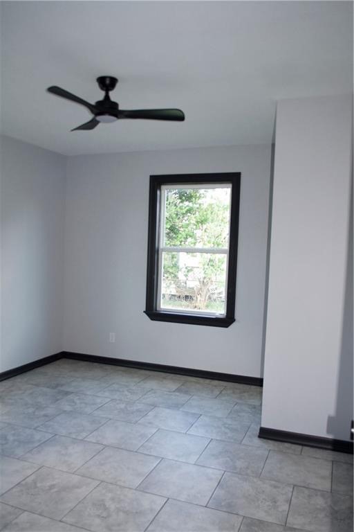 300 East Le Roy Street Three Rivers, TX 78071 - Photo 6 of 15 a view of a livingroom with a ceiling fan and a window