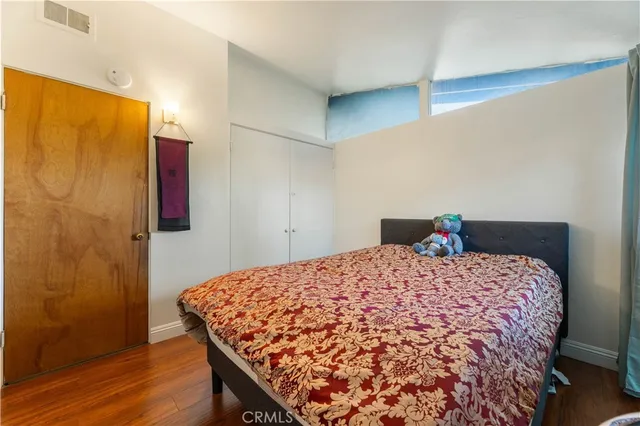 a bedroom with a bed and window