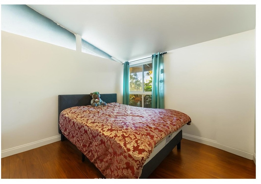 3340 East Poppy Street Long Beach, CA 90805 - Photo 22 of 39 a bedroom with a bed and window