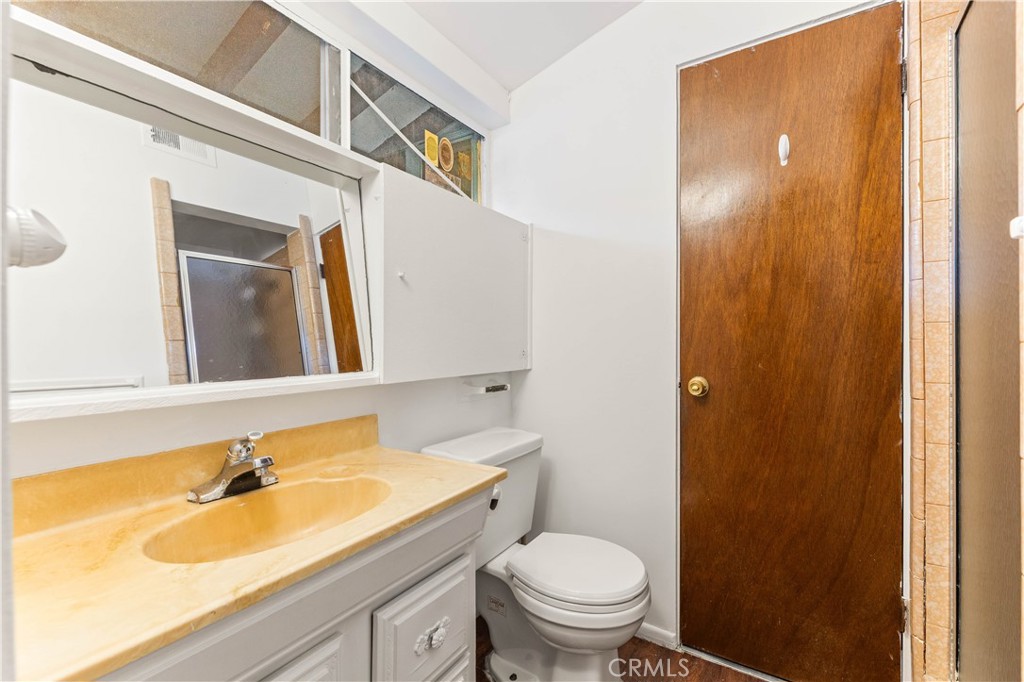3340 East Poppy Street Long Beach, CA 90805 - Photo 25 of 39 a bathroom with a sink and a mirror
