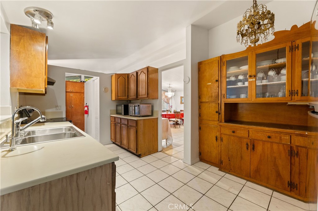 3340 East Poppy Street Long Beach, CA 90805 - Photo 27 of 39 a kitchen with a refrigerator and a sink