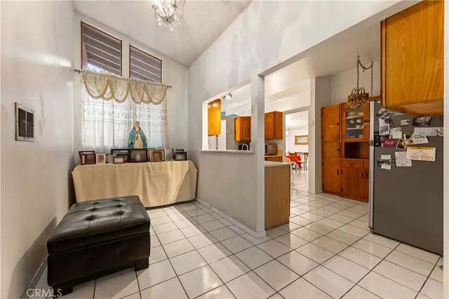 a living room with stainless steel appliances furniture and a window