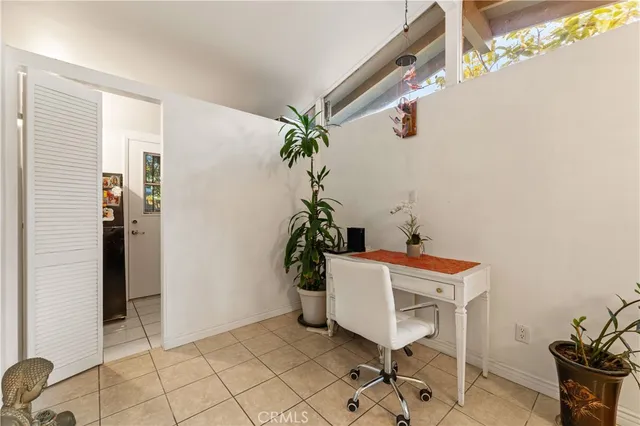 a living room with furniture and a dining table
