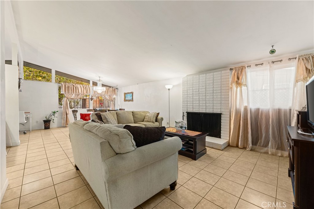 3340 East Poppy Street Long Beach, CA 90805 - Photo 34 of 39 a living room with furniture a fireplace and a flat screen tv