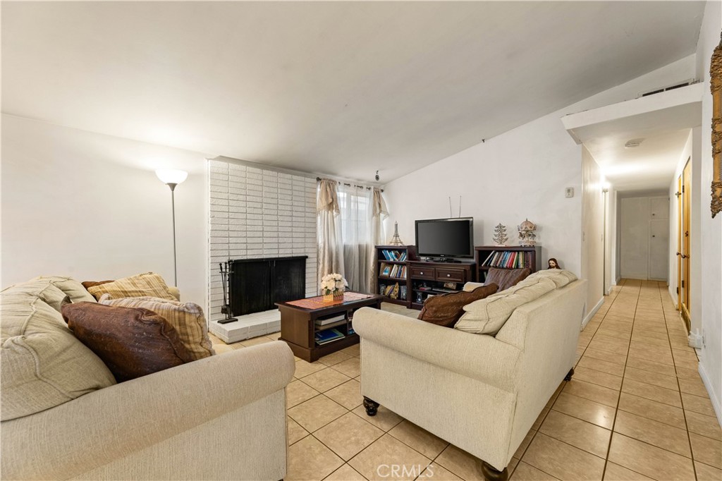3340 East Poppy Street Long Beach, CA 90805 - Photo 36 of 39 a living room with furniture and a fireplace