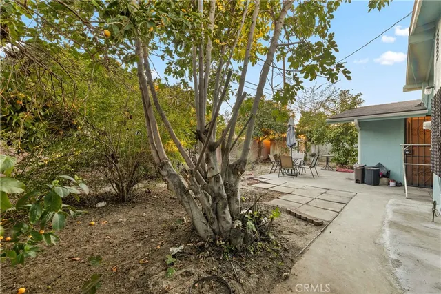 a backyard of a house with table and chairs
