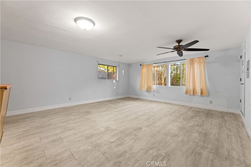 3340 East Poppy Street Long Beach, CA 90805 - Photo 6 of 39 wooden floor in an empty room with a window