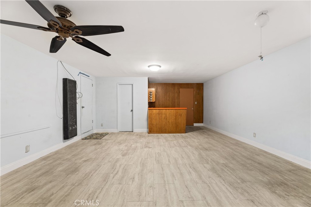 3340 East Poppy Street Long Beach, CA 90805 - Photo 7 of 39 a view of empty room with wooden floor and ceiling fan