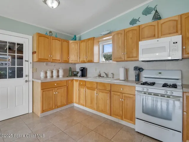a kitchen with granite countertop a sink stainless steel appliances and cabinets
