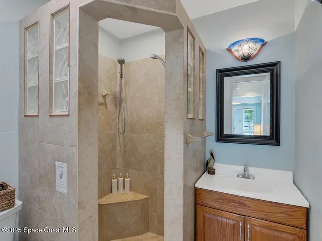 a bathroom with a sink a mirror and a shower