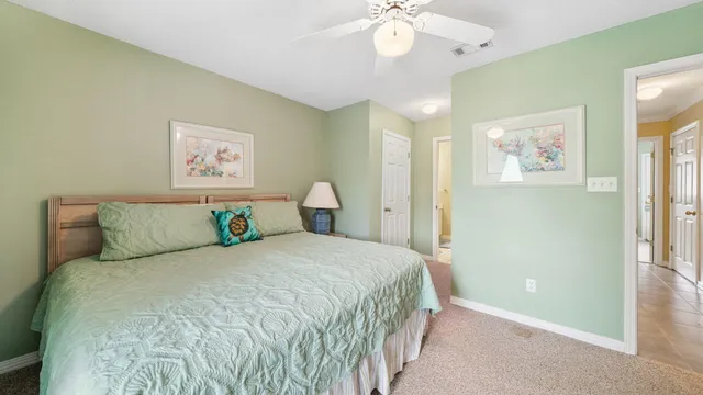 a bedroom with a large bed and a chandelier