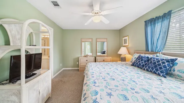 a bedroom with a large bed and a chandelier