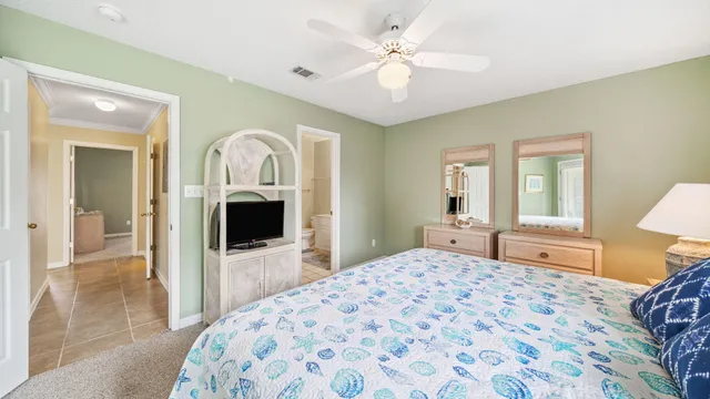 a bedroom with a large bed and a chandelier