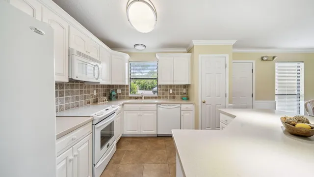 a kitchen with a sink cabinets and window