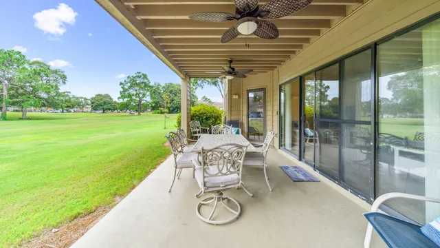 a patio with garden area and outdoor seating