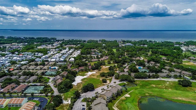 an aerial view of multiple houses with yard