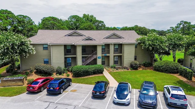 an aerial view of residential houses with outdoor space and street view