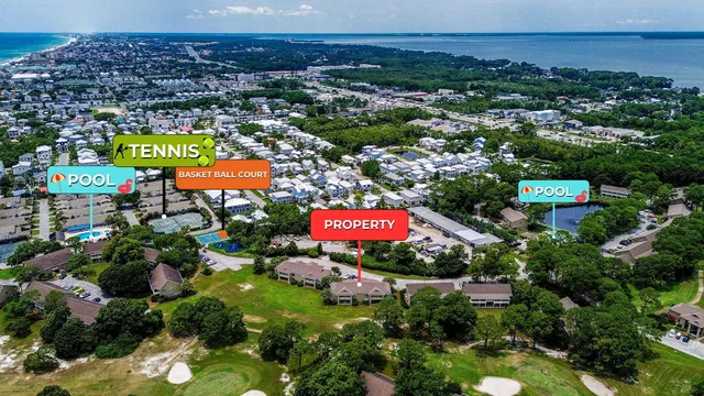 an aerial view of residential houses with outdoor space and trees