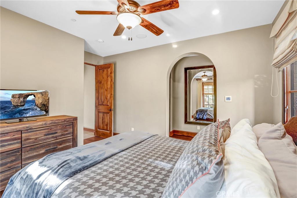 41 Needle Grass Irvine, CA 92603 - Photo 12 of 64 a bedroom with a bed and a chandelier