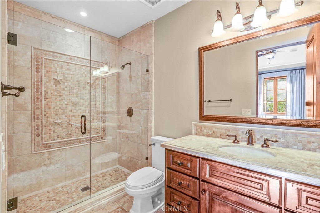 41 Needle Grass Irvine, CA 92603 - Photo 16 of 64 a bathroom with a granite countertop sink toilet mirror and shower