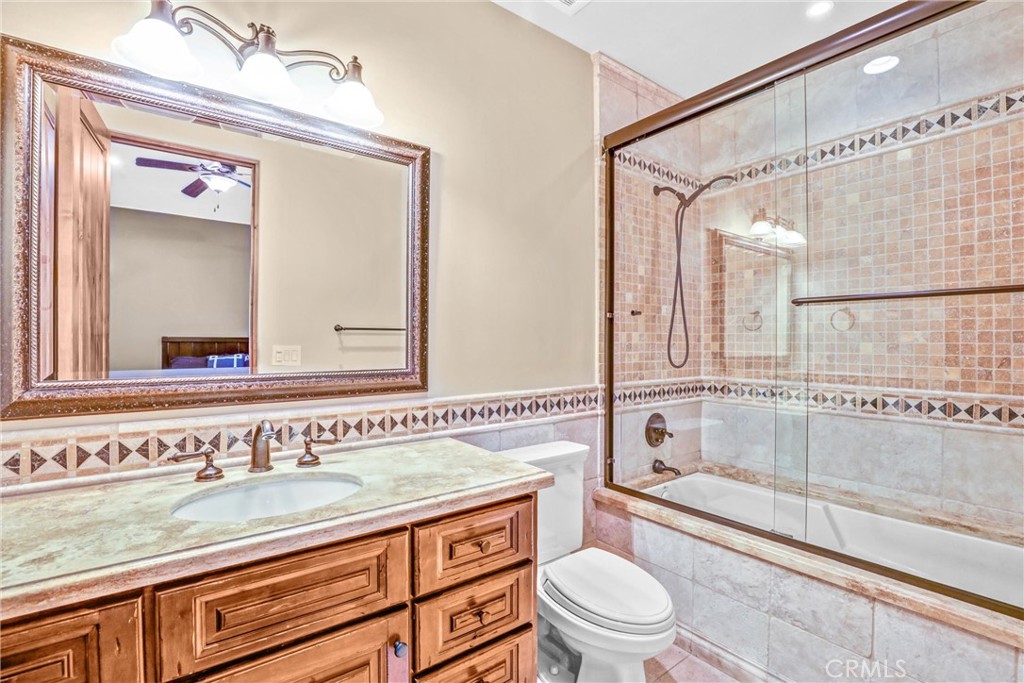 41 Needle Grass Irvine, CA 92603 - Photo 19 of 64 a bathroom with a granite countertop sink a toilet a mirror and shower