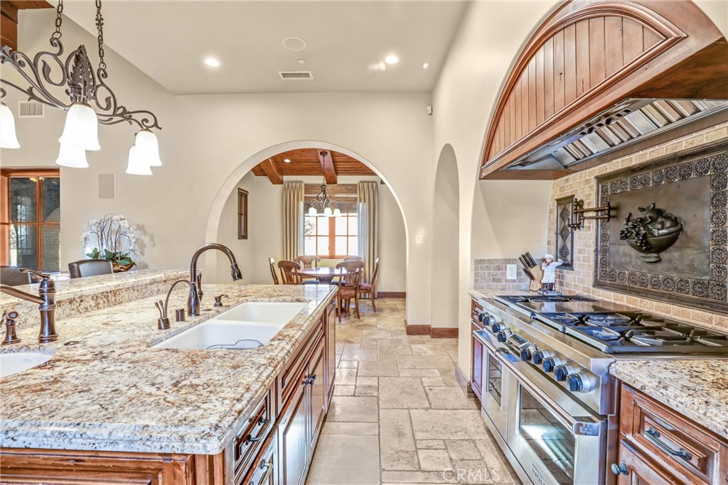 41 Needle Grass Irvine, CA 92603 - Photo 23 of 64 a kitchen with stainless steel appliances granite countertop a stove a sink and a dining table