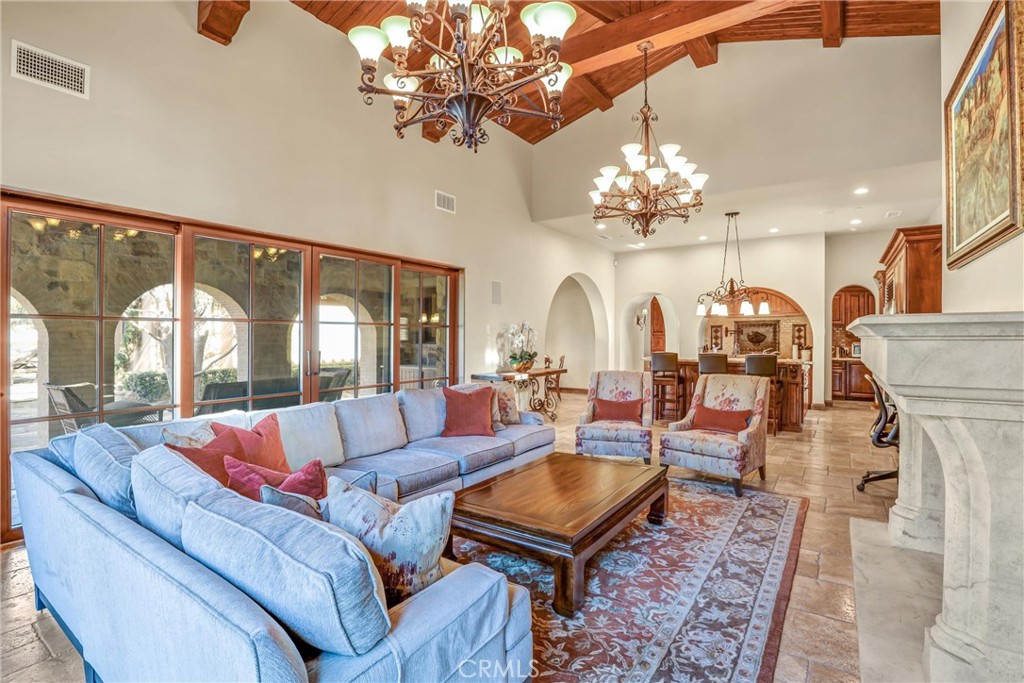 41 Needle Grass Irvine, CA 92603 - Photo 28 of 64 a living room with fireplace furniture and a chandelier