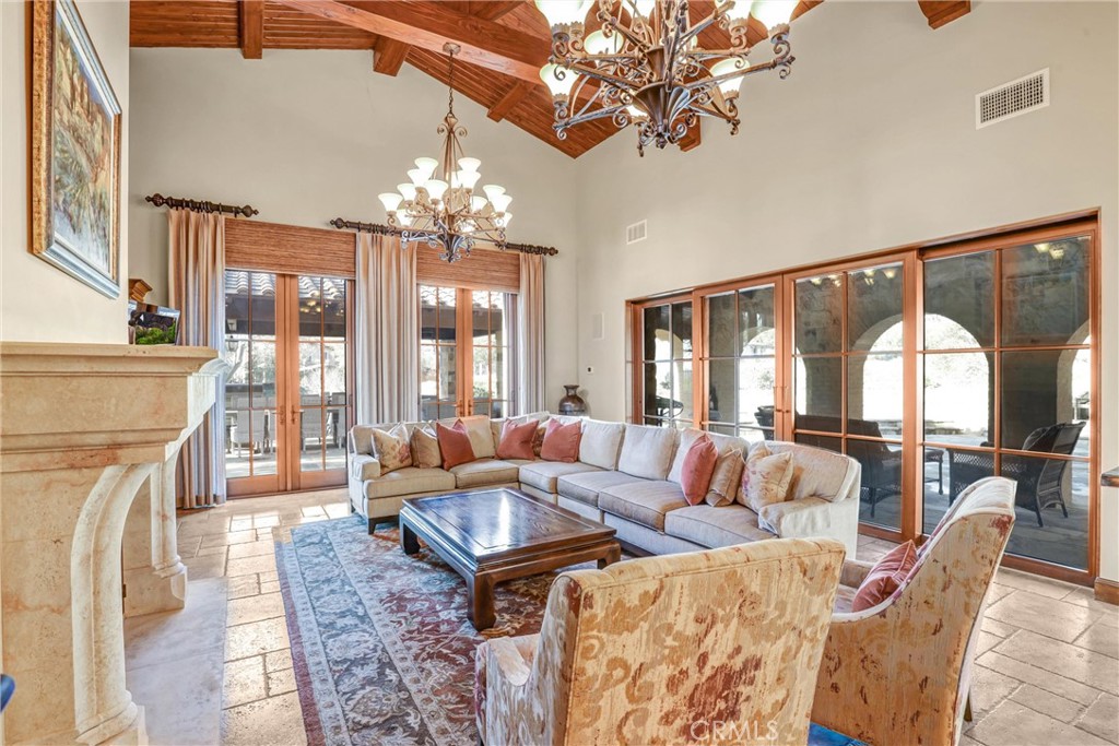 41 Needle Grass Irvine, CA 92603 - Photo 30 of 64 a living room with furniture a chandelier and a fireplace