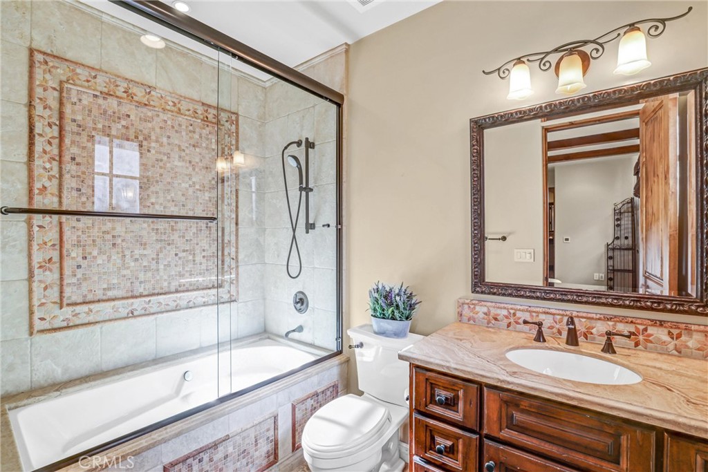 41 Needle Grass Irvine, CA 92603 - Photo 33 of 64 a bathroom with a granite countertop sink toilet a mirror and shower