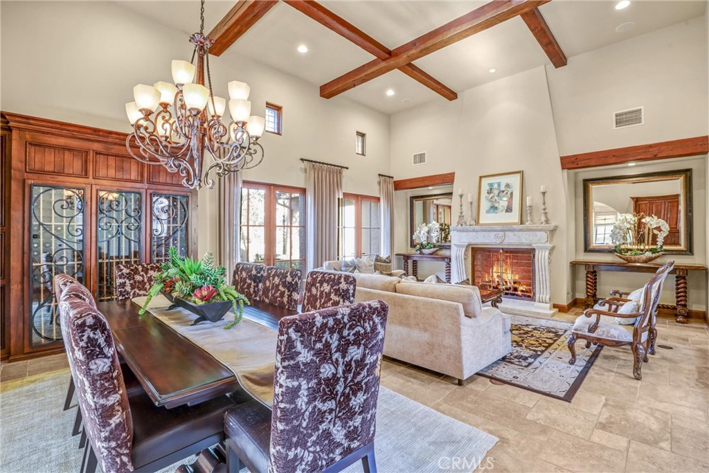 41 Needle Grass Irvine, CA 92603 - Photo 4 of 64 a living room with furniture a chandelier and a fireplace